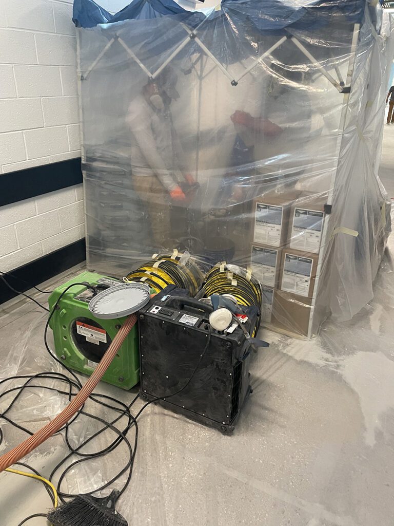 Contractors mixing Westcoat products in a separate, plastic covered area